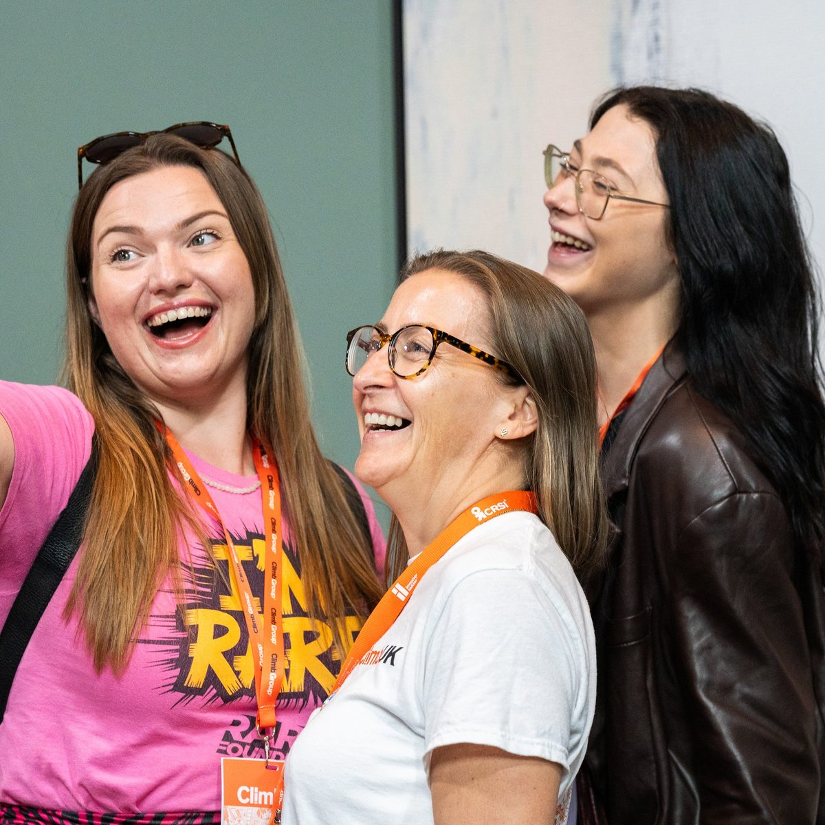 A ClimbUK crew member in an orange T-shirt waving across the floor